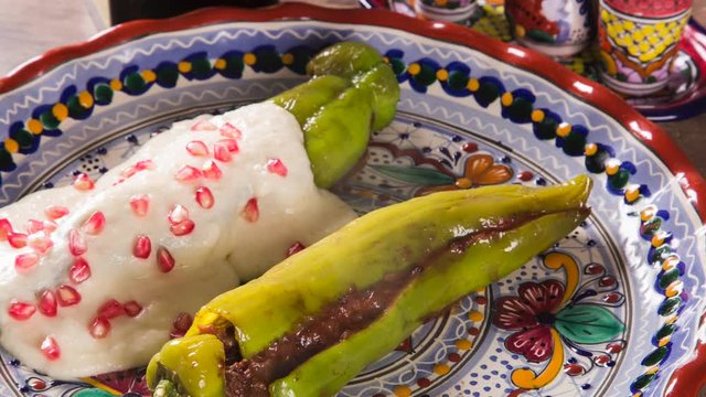 Mexican cuisine - Chiles en nogada. Front view with smoke.