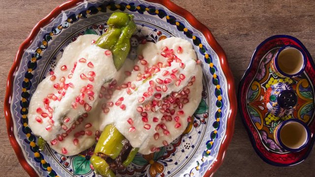 Mexican cuisine - Chiles en nogada. Top view with smoke.