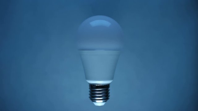 Energy-saving, eco-friendly Led bulb lamp lights up on a light background. You can see the structure of the led lamp. Closeup