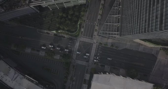 Ungraded, Orbit aerial flight rotation above urban city's intersection. Drone, 4K.