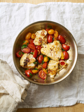 Roasted white fish with cherry tomatoes and lemon rind