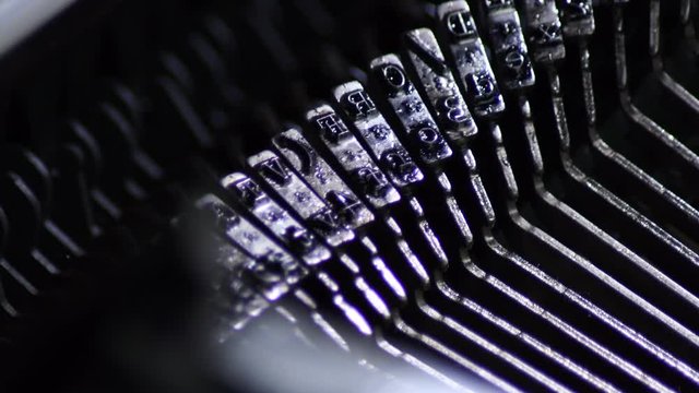 Old typo keys of a manual qwerty typewriter writing