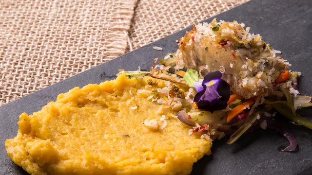 White fish with banana puree. Front view with smoke.