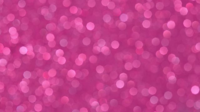 Abstract background with shining pink bokeh sparkles. Glittering Particles. Defocused circular facula. Natural Floating Organic Abstract Background. Christmas and Happy new year.