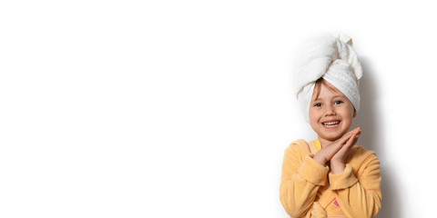 Cute happy adorable little girl dressed in yellow bathrobe with towel on head - obrazy, fototapety, plakaty