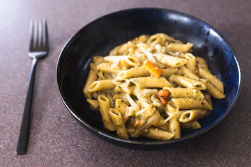 plant-based food, vegan one pot pesto pasta with onions and capsicums