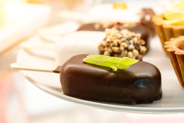 A cake in the form of popsicle poured chocolate.