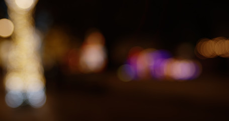 Abstract colorful defocused bokeh background. Blurred City street lights and reflections in rain at night.