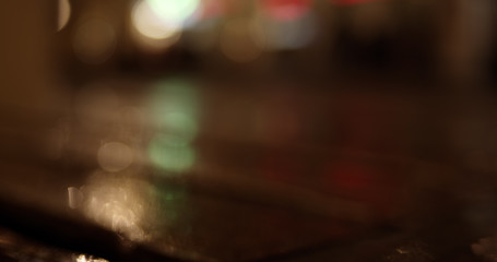 Abstract colorful defocused bokeh background. Blurred City street lights and reflections in rain at night.