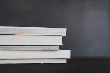 stack of books shot from eye level with shallow depth of field.