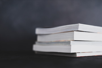 stack of books shot from eye level with shallow depth of field.