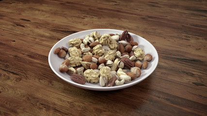 Mixed Nuts in White Bowl on Wooden Table.