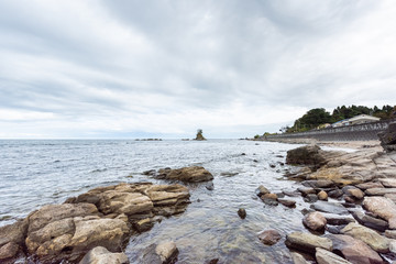 Fototapeta na wymiar Toyama Bay is a bay located on the Amaharashi Coast,Onnaiwa Rock is a beauty spot of Amaharashi Coast.Japan