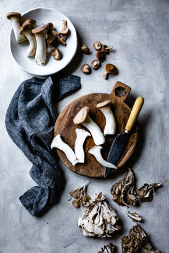 Overhead view of trumpet and maitake mushrooms on table
