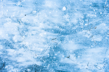 Background. Ice with bubbles and dry grass.