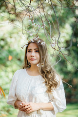 Beautiful asian woman with autumn leaves, flower and fall yellow leaves background at Hagley park, Christchruch, New Zealand.