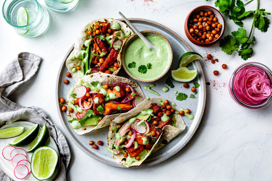 Sweet potato chickpea tacos with cilantro cream served on plate