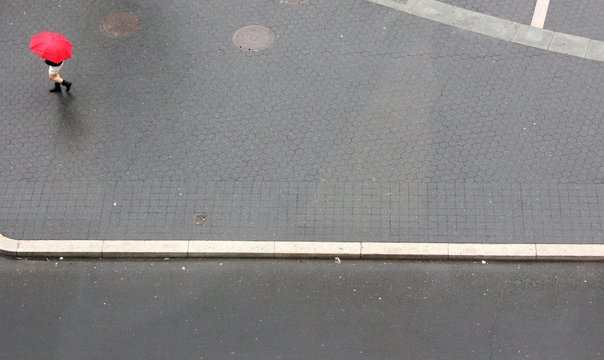 High Angle View Of Woman Walking With Umbrella On Road