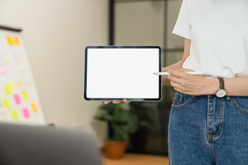 Closeup of woman hand holding digital tablet on the table and the screen is blank.