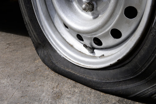 Flat Tire Of Old Car Park On The Street