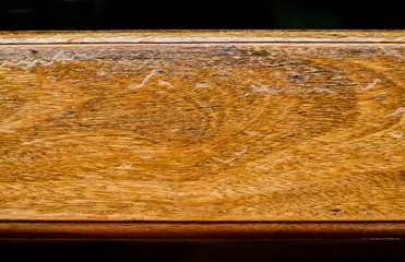Piece of brown wet wood over black background