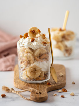 trifle dessert with banana, mascarpone, cookies and almonds