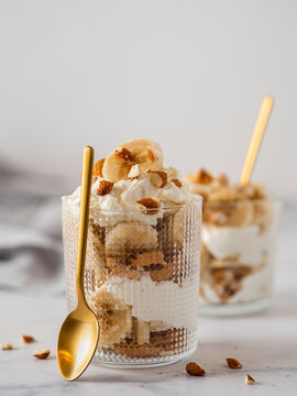 trifle dessert with banana, mascarpone, cookies and almonds
