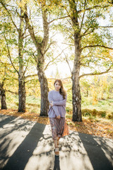 Beautiful asian woman with autumn leaves, flower and fall yellow leaves background at  Christchruch, New Zealand.