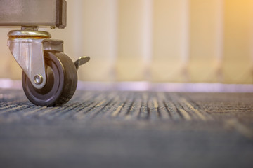 Small black rubber wheels on the carpet.