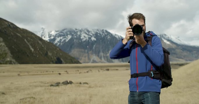 Young adventure photographer, using  professional camera equipment in the Mt Cook region of New Zealand.
