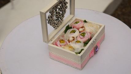 Wedding box with flowers and rings.
