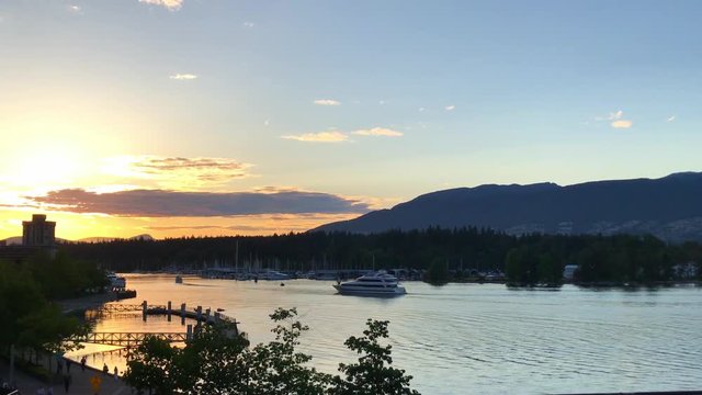 Lake series scene yacht moving golden hour by boat slips mountains towards sunset
