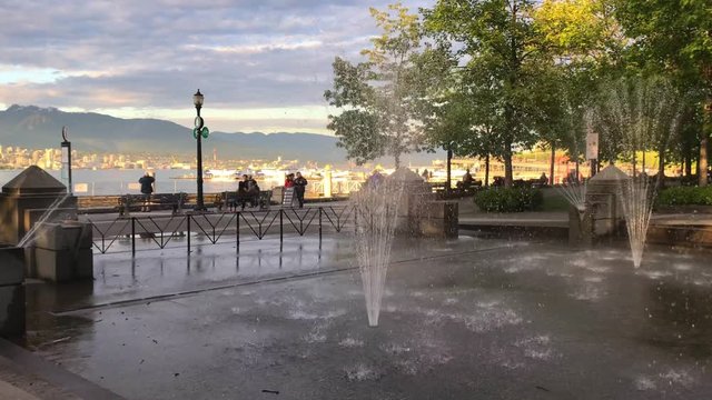 Lake series People walking by Fountains Mountains Bay in Golden Hour