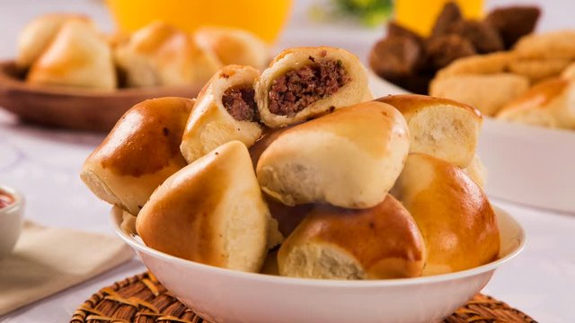 Brazilian snack. Meat Esfiha portion on the table with smoke.