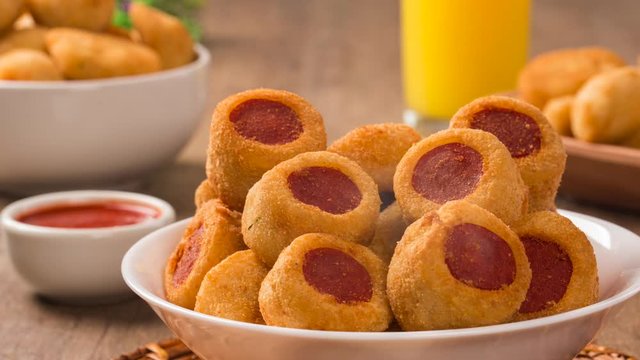 Sausage fried snacks. Brazilian snacks on wooden backgroung with smoke.