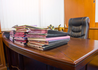 Empty workplace in office and pile of  documents on office desk, Office for boss with sun illumination