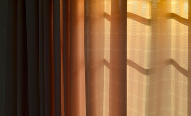 Gradation orange curtain with sunshine at window.