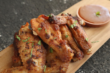 Delicious chicken wings, baked or fried chicken wings served with hot spicy  barbeque sauce