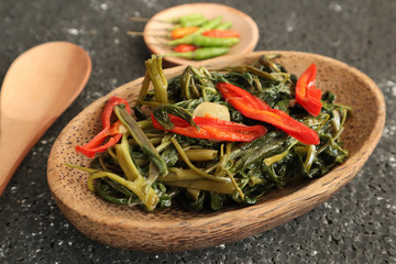 Stir fried water spinach or cah kangkung. Traditional asian indonesian food, cooked veggies, spicy vegetable dish for vegan, vegetarian meal