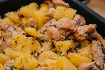 Baked potatoes with white meat. Oven with chicken in the oven. Marinated pork
