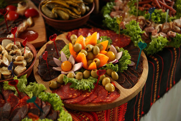Red pepper with meat and caviar. Green leaves.