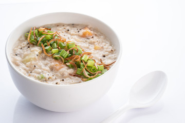 ramadhan famous food bubur lambuk in a white bowl and background