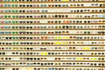 Texture of sunglasses store display in a mall. Unusual texture backdrop with place for text