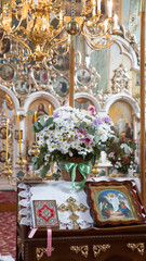 Bouquet of flowers with candles in the church.