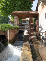 mill with metal wheel inserted in the artificial canal that conveys the water of the river
