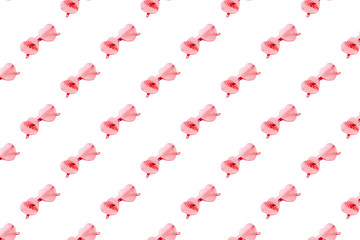 Pattern from stylish heart shaped glasses with shadow from palm leaves. Fashion summer background.
