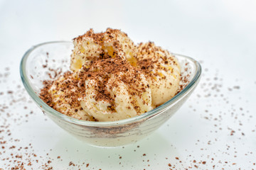 glass bowl with balls of vanilla ice cream sprinkled with chocolate chips