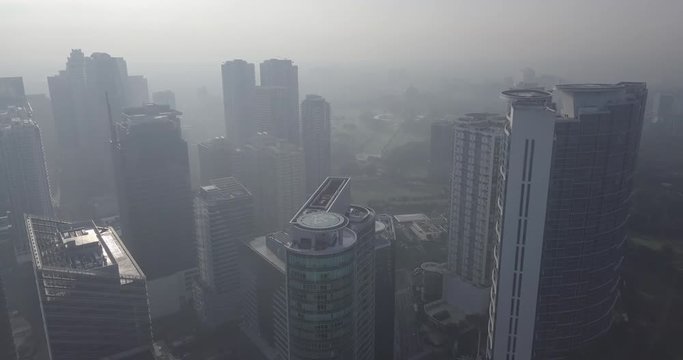 Ungraded, Straight aerial flight through skyscrapers approaching park area. Drone, 4K.