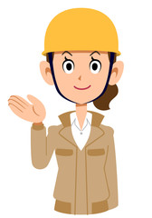 案内するベージュ色の作業着を着てヘルメットを被った女性
