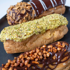 delicious and beautiful eclairs with chocolate and pistachio glazes